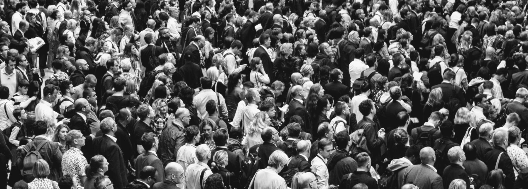 A dense station concourse crowd seen from above